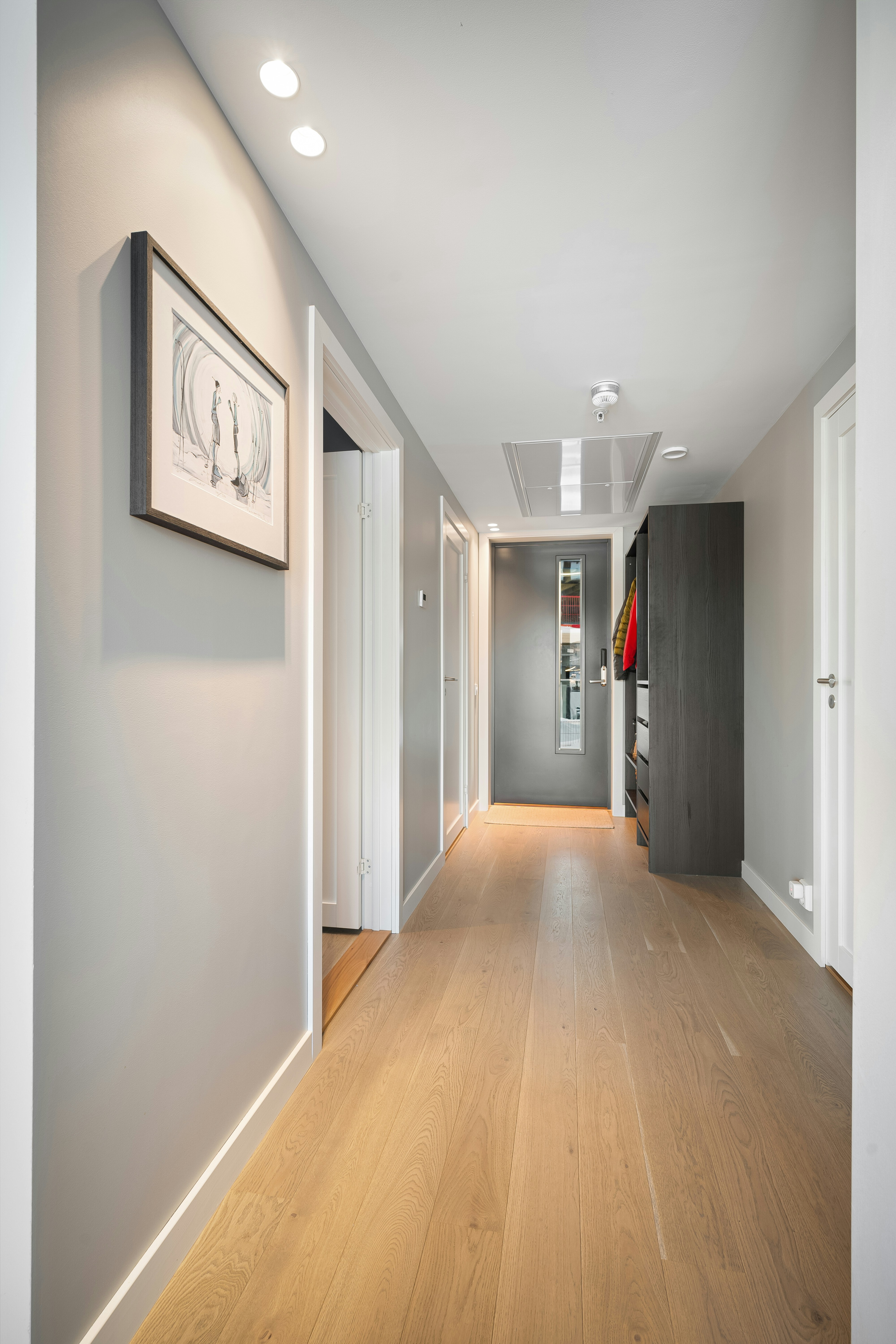 A long hallway with a picture hanging on the wall